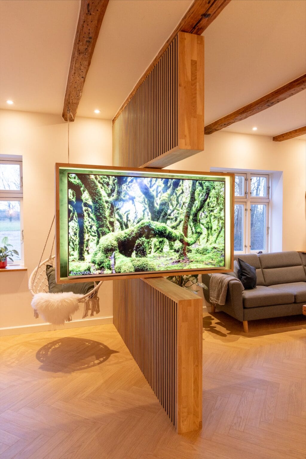 Modern living room with large nature-themed TV display.