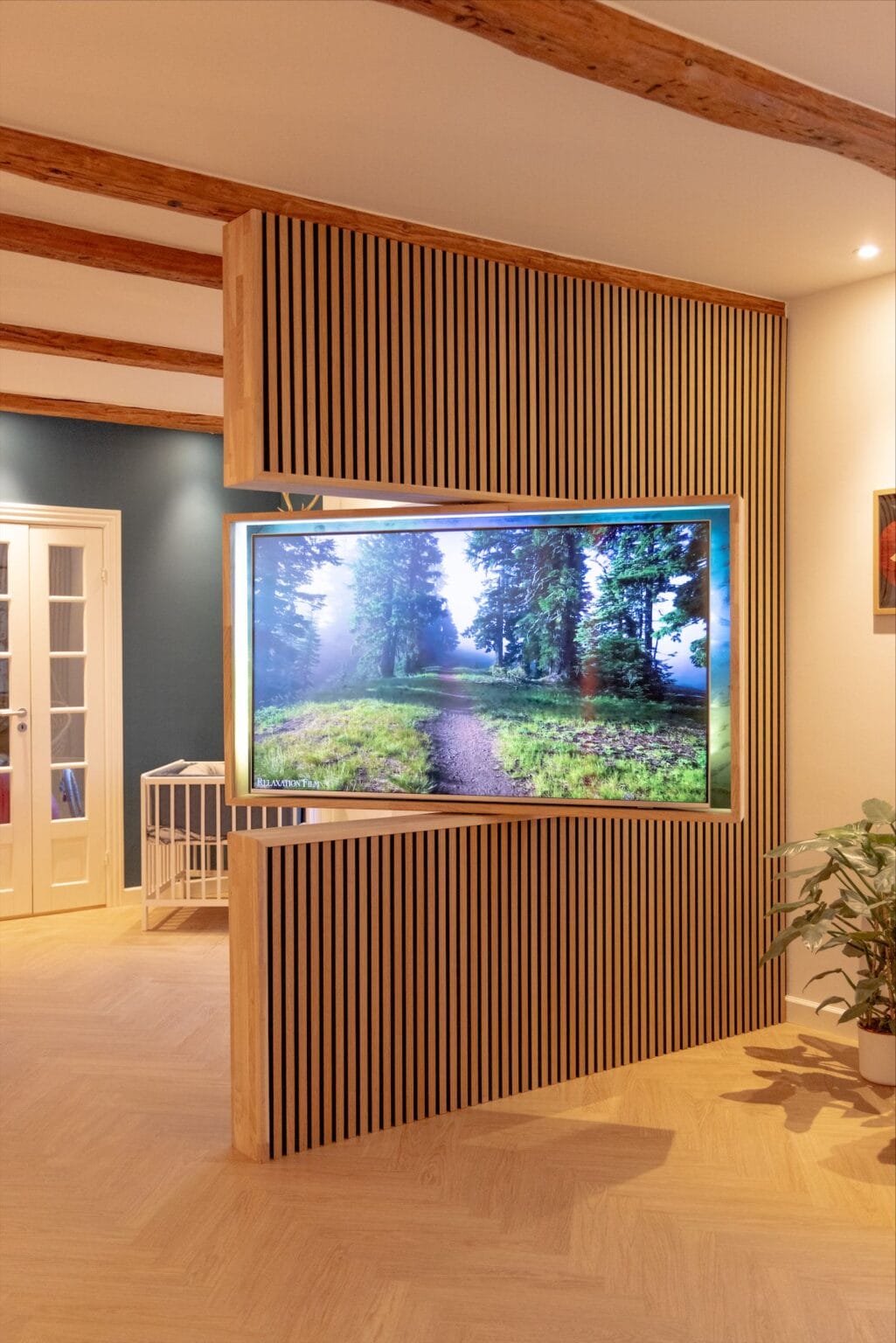 Modern interior with large forest scene on screen.